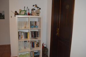 a book shelf filled with books next to a door at Miramar Pansiyon in Kaş