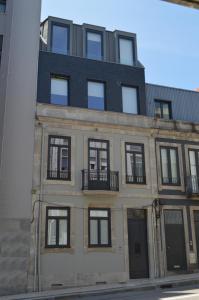 an apartment building with a black roof at Camões by Trindade Sweet Home in Porto