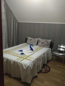 a bedroom with a bed with a towel on it at Guest House Orchid in Kropyvnytskyi