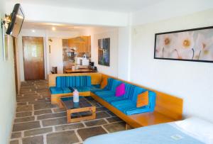 a living room with a couch and a table at Apollonia Hotel Apartments in Varkiza