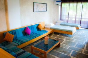 a living room with two couches and a table at Apollonia Hotel Apartments in Varkiza