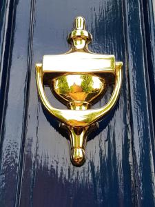 a gold door handle on a blue door at Alexandra Lodge Guest House in Chester