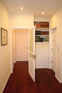 a hallway with a door and a book shelf at Porto Patricio Apartments in Porto