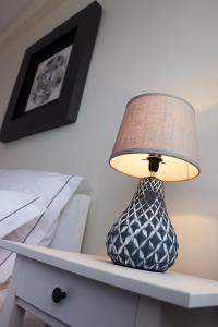 a lamp sitting on top of a dresser at Porto Patricio Apartments in Porto