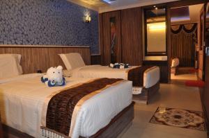 a hotel room with two beds in a room at Astoria Residency in Ooty