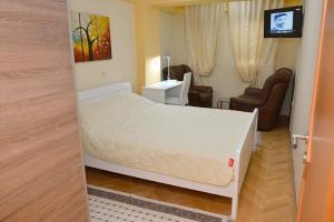 a bedroom with a bed and a living room at Utopia Apartments Ohrid in Ohrid