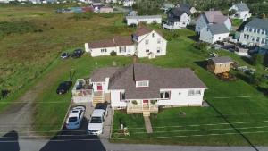 an aerial view of a house with cars parked in the yard at Mama`s By The Sea B&B in Clark's Harbour
