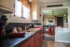 a kitchen with a sink and a counter top at Mama`s By The Sea B&B in Clark's Harbour