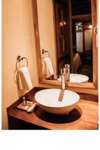 a bathroom with a sink and a mirror at Hotel Diego de Mazariegos in San Cristóbal de Las Casas