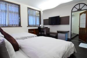 Postel nebo postele na pokoji v ubytování Yuh-Tarng Hotel