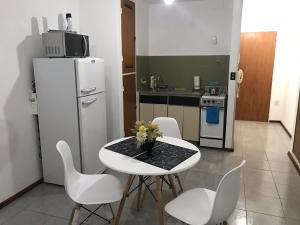 cocina con mesa, sillas y nevera en Apartamento La Mansa en Córdoba