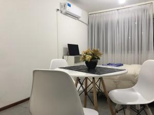 comedor con mesa y sillas blancas en Apartamento La Mansa en Córdoba