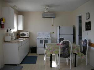 a kitchen with a table with chairs and a stove at Birch Haven by the Beach in Wasaga Beach