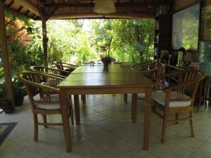 a wooden table and chairs in a room at Bali Sandat in Tejakula