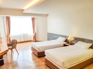 Postel nebo postele na pokoji v ubytování Phayao Gateway Hotel