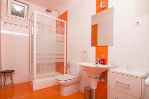 a bathroom with a shower and a toilet and a sink at Apartment Botta in Mimice +52 photos