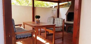 a porch with a table and chairs and a fireplace at Apartment Bjanka in Pakoštane