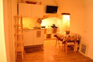 a kitchen with a table and a kitchen with a ladder at ESCIA' b&b in Noci