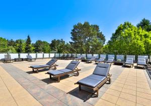 a row of chaise lounges on a patio at Ośrodek wypoczynkowy Balt-Tur Feel Well Resort in Jastrzębia Góra