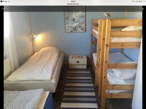 a small bedroom with two bunk beds and a ladder at Kajsa krabbat Vandrarhem in Kungshamn +29 photos