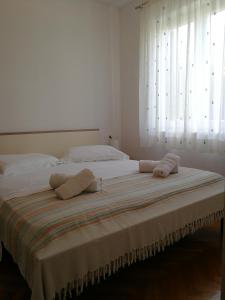 a bedroom with a large bed with two pillows on it at Apartment Violeta 2 in Funtana