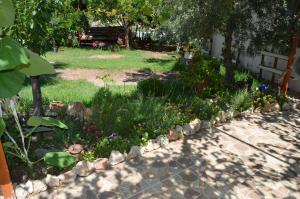 a garden with flowers and rocks in a yard at Beyoglu Pansiyon in Patara