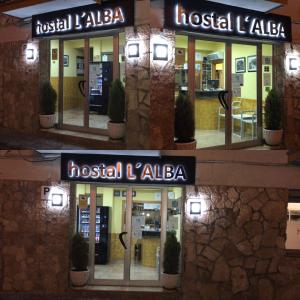 a building with a sign that reads hostel l alba at Hostal L'Alba in Tossa de Mar