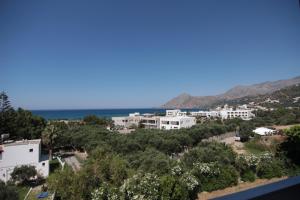 a view of a town with the ocean in the background at Lofos Hotel in Plakias
