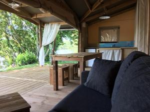 a living room with a table and a couch at camping des ribieres in Confolens