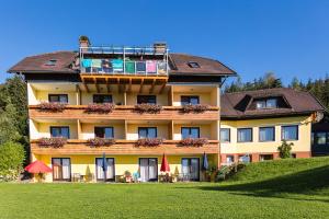 a large building with a balcony on top of it at Hotel Fasching in Sankt Georgen am Längsee