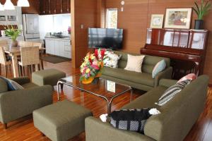 a living room with two couches and a television at Tomonoya Ishigaki in Ishigaki Island