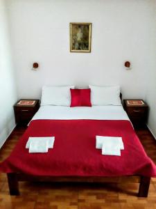 A bed or beds in a room at Oaza Guest House