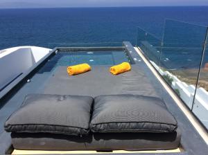 a swimming pool on a boat in the ocean at Almyra Oia Suites in Oia +87 photos
