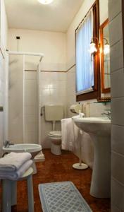 a bathroom with a sink and a toilet and a shower at Albergo La Bersagliera in Noventa di Piave