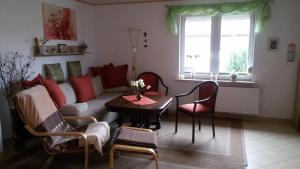 a living room with a couch and a table at Haus Sonne,Seeblick 57 in Boiensdorf