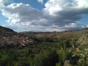 a city in the hills under a cloudy sky at Casas Bajas Alojamiento Rural in Casas Bajas
