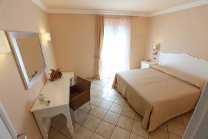 A bed or beds in a room at Residence Hotel La Giara