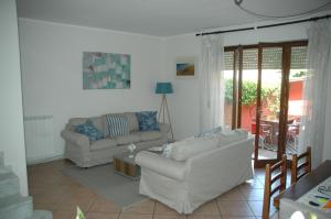 a living room with two couches and a table at Casa Mario dei Pini in Viareggio