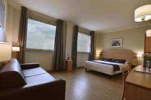 Postel nebo postele na pokoji v ubytování Tulip Inn Turin West Rivoli