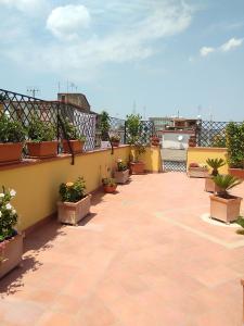 a patio with potted plants on a balcony at Home To Fly in Naples