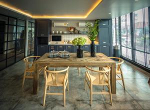 a kitchen with a wooden table and chairs at Apartelle Jatujak Hotel in Bangkok