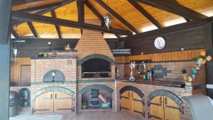 a kitchen with a large brick oven with a clock at Kys House in Techirghiol