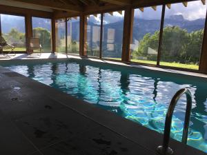 a swimming pool with a view of the mountains at Le Caprice Des Neiges in Crest-Voland