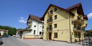 a yellow building on the side of a street at Casa Micu in Sibiu