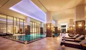 a hotel lobby with a swimming pool and a building at Dedeman Zonguldak in Zonguldak