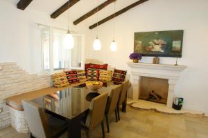 a dining room with a table and a fireplace at Robinson Villa Afrodita in Nerežišća