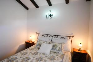a bedroom with a bed with pillows and two lamps at Robinson Villa Afrodita in Nerežišća
