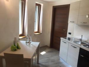 a small kitchen with a table and a sink at B&B San Pellegrino Terme in Zogno +14 photos