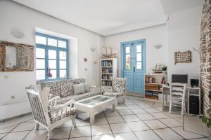 a living room with a couch and chairs and a table at Hotel Mantalena in Antiparos Town