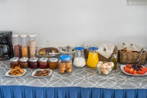 a table with food and jars and plates of food at Hotel Mantalena in Antiparos Town